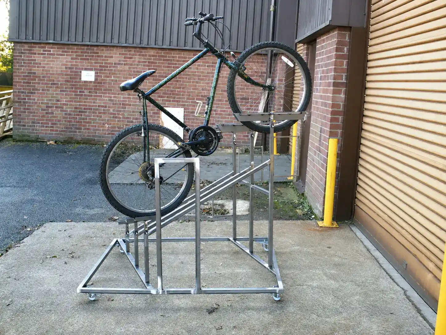 Mobile Multi-Level Bicycle Display Rack manufactured by Techrail Wheeled fabricated steel rack designed to present bicycles at different heights.