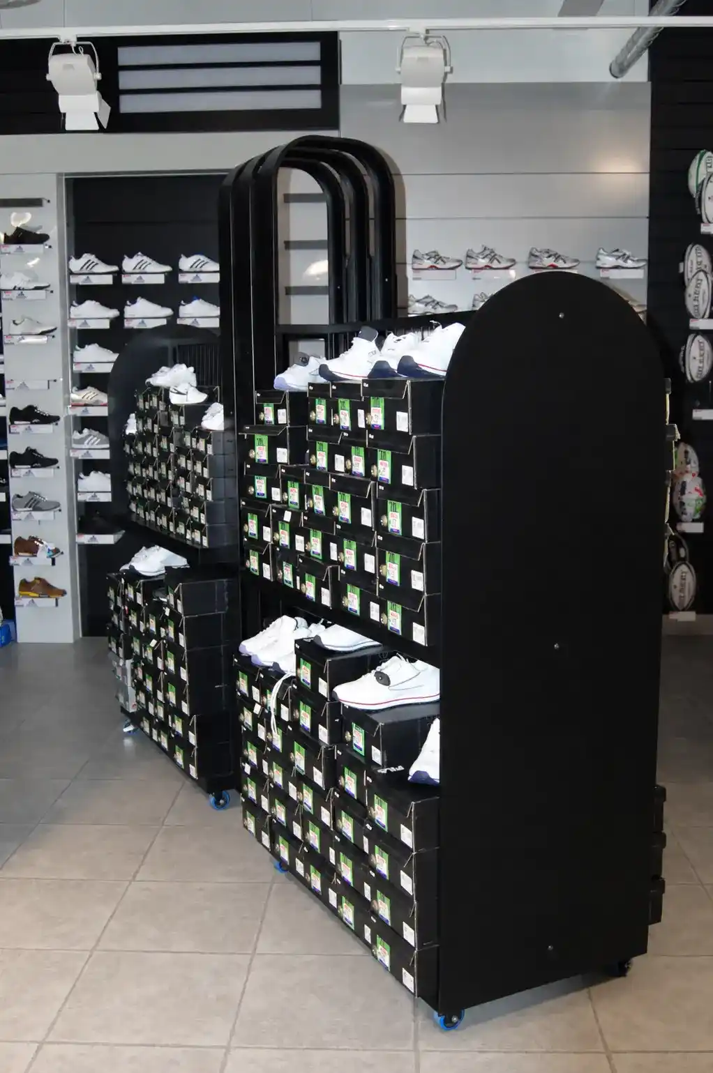 Mobile Footwear Stock and Display Unit manufactured by Techrail Powder-coated wheeled retail fixture combining shoe display shelves with boxed stock storage.