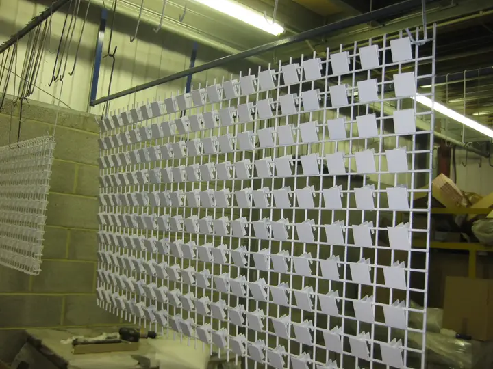 Powder-coated sheet metal parts on Techrail's powder coating conveyor line